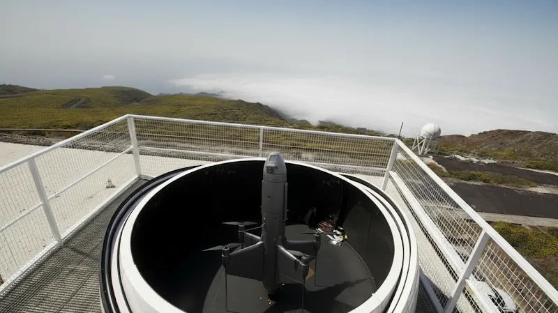 Radar dome installed on a rooftop platform overlooking hills